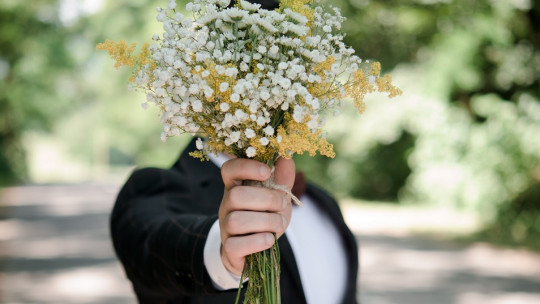 Man with bouquet of flowers.