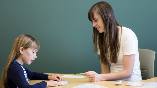 Educator with girl with dyslexia