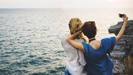 Women taking a selfie on the coast.