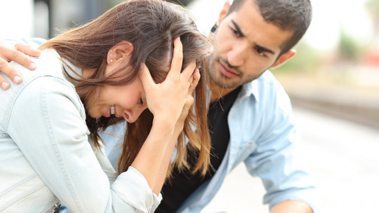 Man comforting a crying woman.