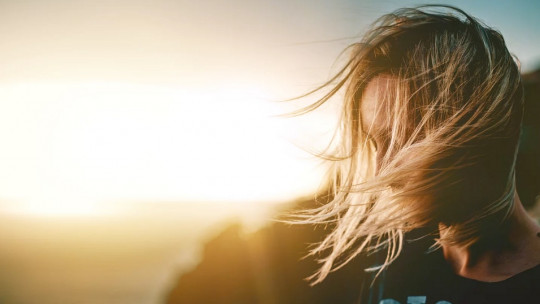 Woman in front of a sunset.