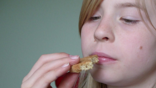 Girl smelling food.