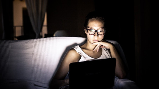 Woman using a laptop.