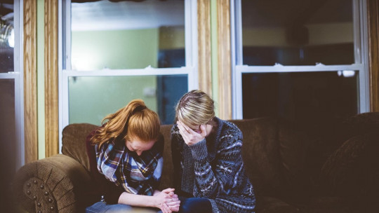 Women crying together.