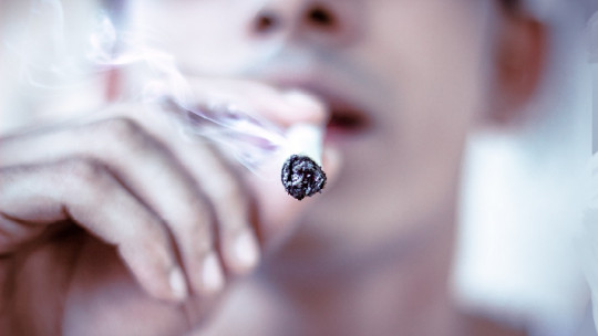 young man smoking cigar