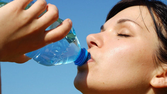 Woman drinking water.