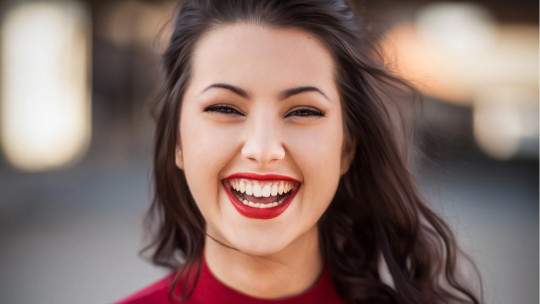 Brunette woman smiling.