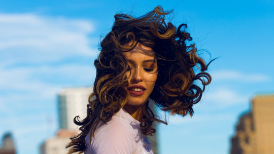 Young woman with curly hair.