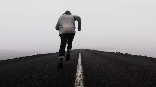 Man running in the fog.